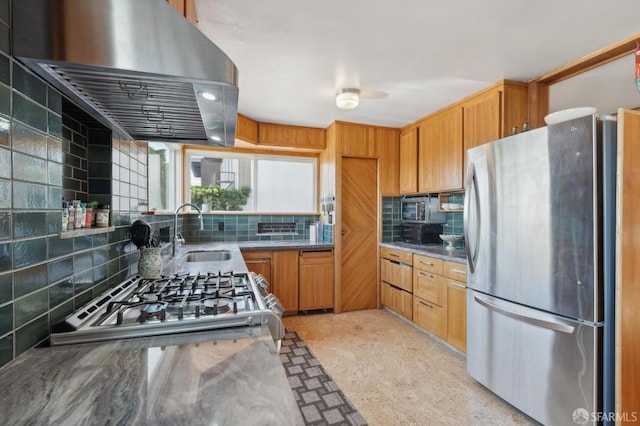 kitchen with ventilation hood, decorative backsplash, brown cabinetry, stainless steel appliances, and a sink