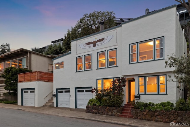 view of front of home featuring stucco siding and a garage