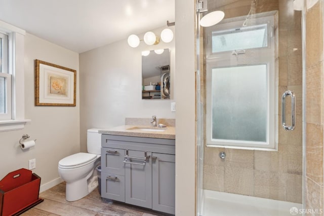 full bath with a shower stall, vanity, toilet, and wood finished floors