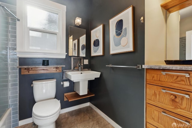 full bathroom with tile patterned floors, toilet, baseboards, and shower / washtub combination