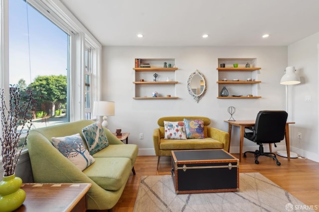 living room featuring recessed lighting, baseboards, and wood finished floors