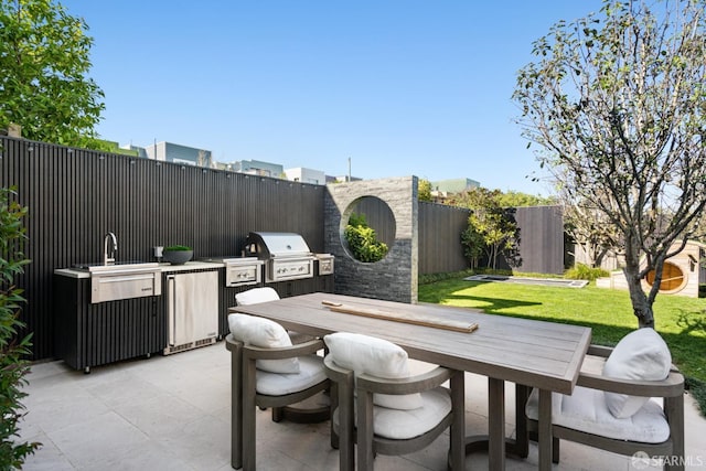 view of patio / terrace featuring exterior kitchen and a grill