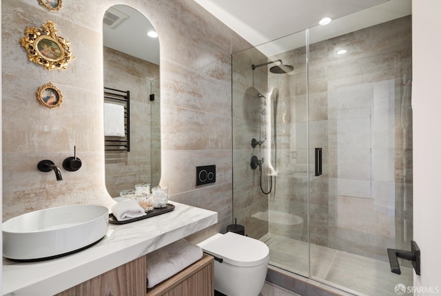 bathroom with vanity, a shower with shower door, and toilet