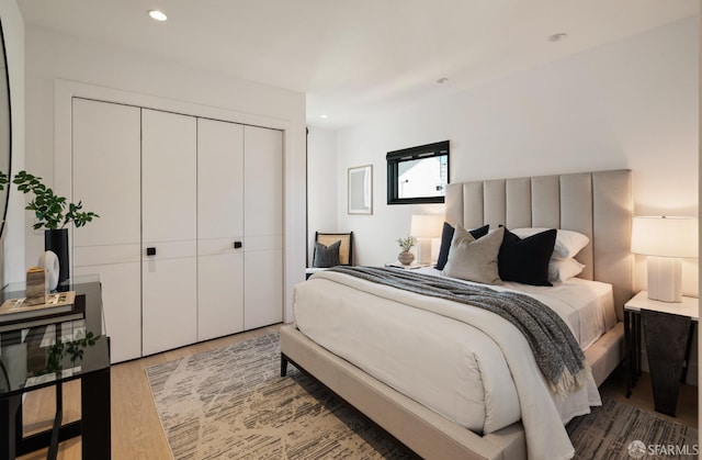 bedroom with hardwood / wood-style floors and a closet