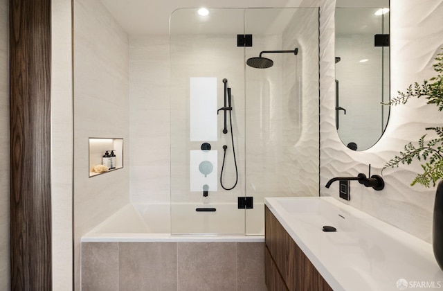 bathroom with a shower with door and vanity