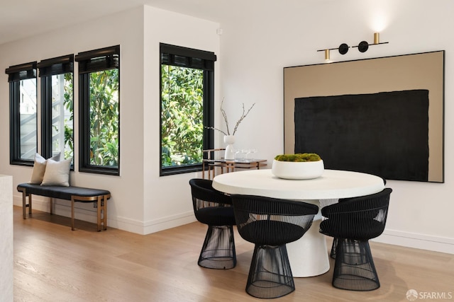 dining space with light hardwood / wood-style floors