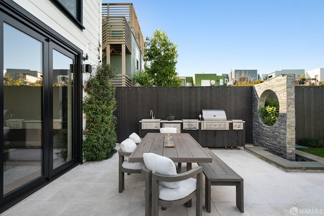 view of patio with an outdoor kitchen and area for grilling