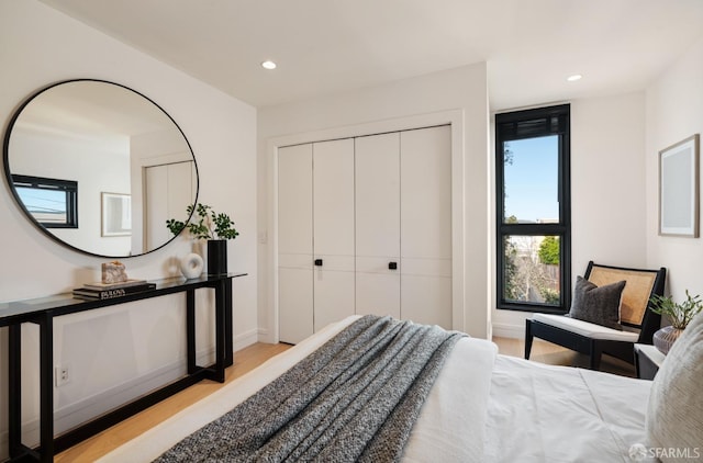 bedroom featuring a closet and light hardwood / wood-style flooring