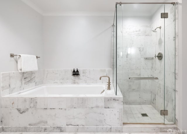 bathroom featuring ornamental molding and separate shower and tub