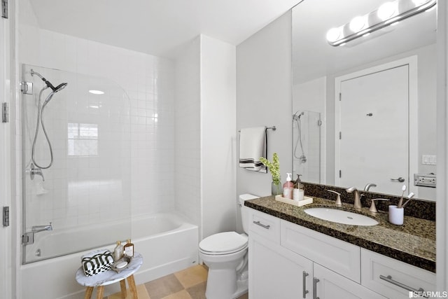 full bathroom featuring toilet, vanity, and tiled shower / bath