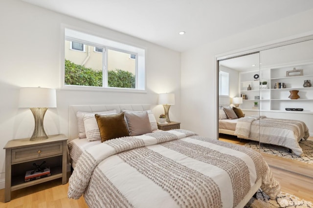 bedroom featuring a closet, recessed lighting, and light wood-style floors