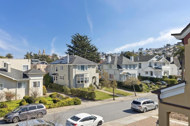 view of road with sidewalks, a residential view, and curbs