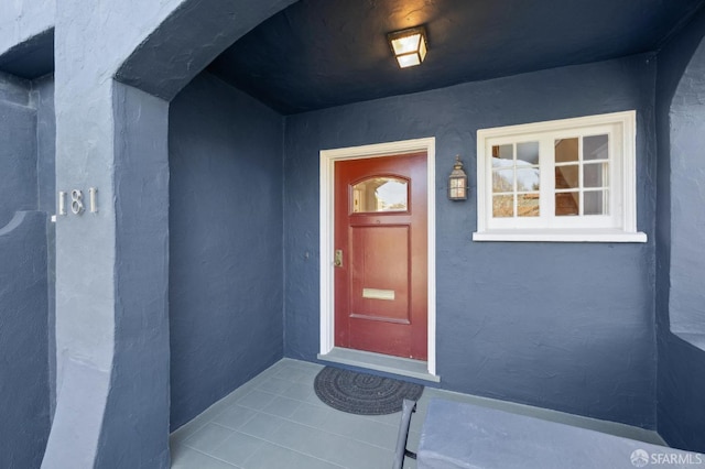 entrance to property with stucco siding