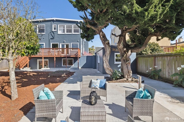 exterior space with a fenced backyard, stairway, a deck, and an outdoor living space