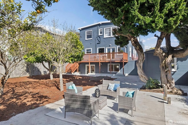 back of property featuring a patio, stairway, fence, a deck, and outdoor lounge area