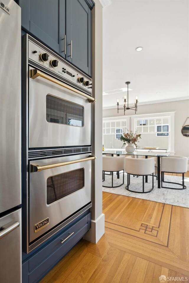 kitchen with appliances with stainless steel finishes, a chandelier, and recessed lighting