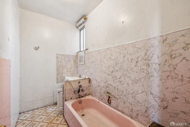 bathroom featuring tile walls, tile patterned floors, vanity, and a bath