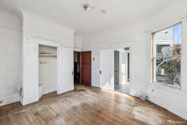 unfurnished bedroom with a closet and wood finished floors