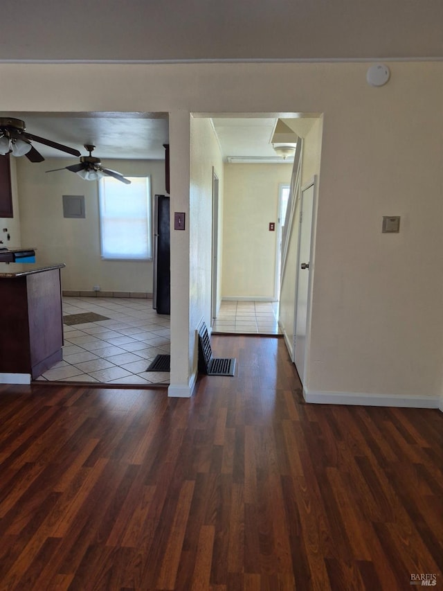 hall featuring wood finished floors and baseboards