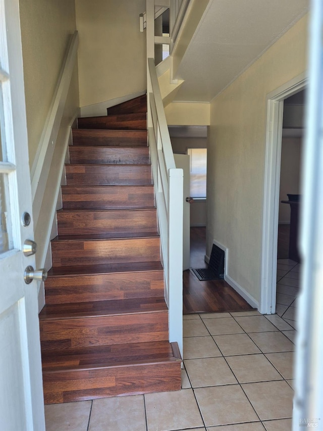 stairs featuring tile patterned floors