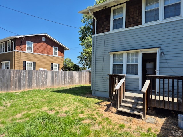 view of yard with fence and a wooden deck