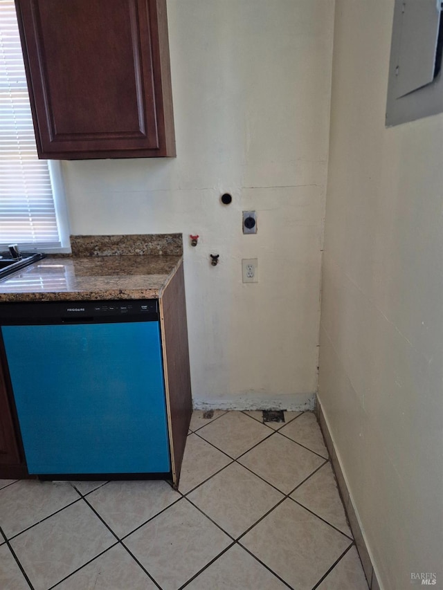 laundry area featuring light tile patterned floors, hookup for an electric dryer, electric panel, and baseboards