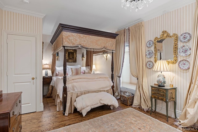 bedroom with ornamental molding, a notable chandelier, wood finished floors, and wallpapered walls