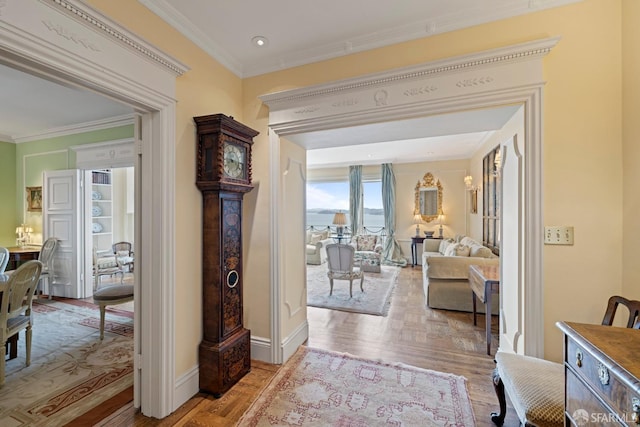 hall with parquet flooring, baseboards, and ornamental molding