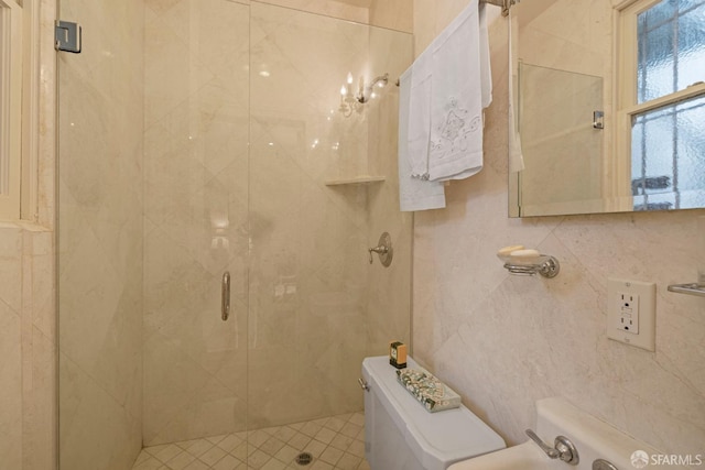 full bathroom with toilet, a shower stall, and tile walls