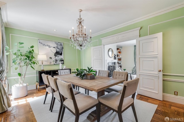 dining space with an inviting chandelier, baseboards, and ornamental molding