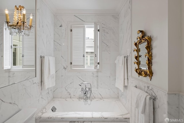 full bathroom with crown molding, a garden tub, toilet, tile walls, and a notable chandelier