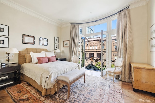 bedroom with access to exterior, crown molding, and light parquet flooring