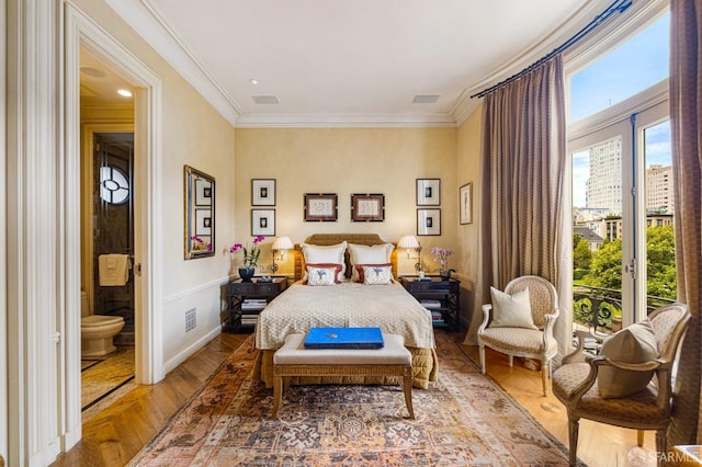 bedroom featuring hardwood / wood-style floors, access to outside, crown molding, and connected bathroom