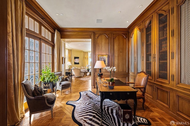 living area with ornamental molding and light parquet floors