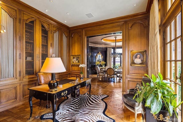 sitting room with wooden walls, parquet floors, and a chandelier