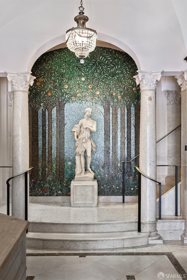 interior space featuring a notable chandelier and ornate columns