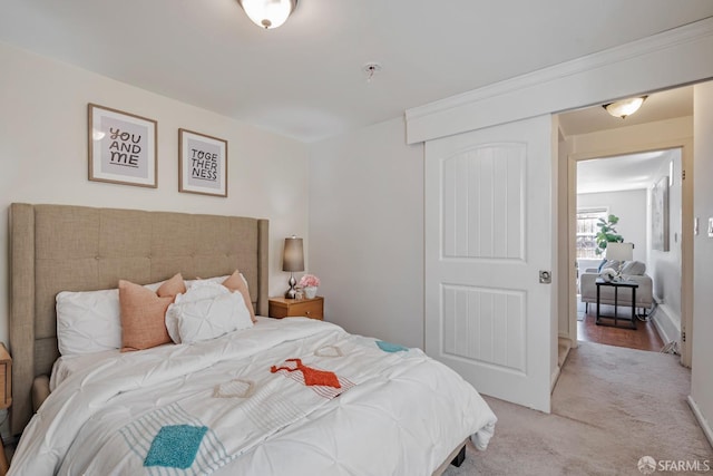 bedroom featuring light carpet and baseboards