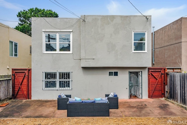 rear view of property with a fenced backyard, stucco siding, and a patio