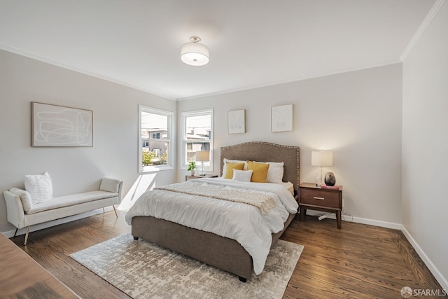bedroom featuring crown molding, baseboards, and wood finished floors