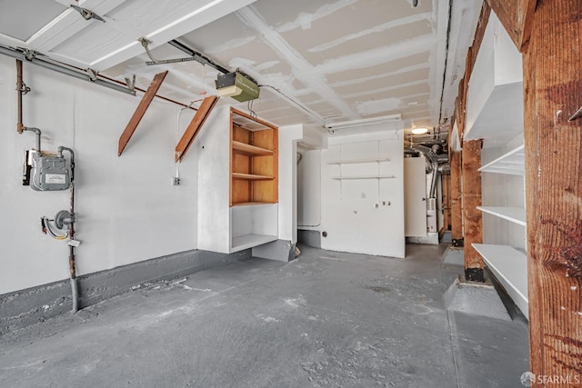 garage with a garage door opener and water heater