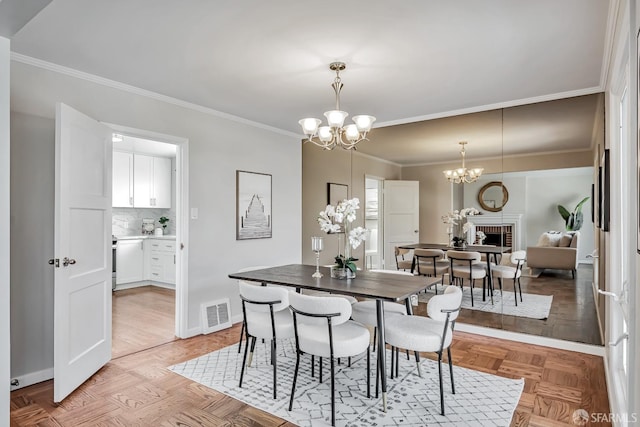 dining space with a chandelier, ornamental molding, and baseboards