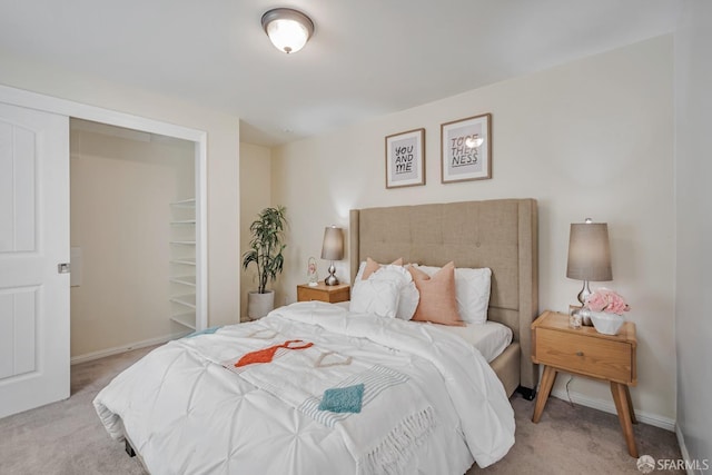 carpeted bedroom with baseboards and a closet