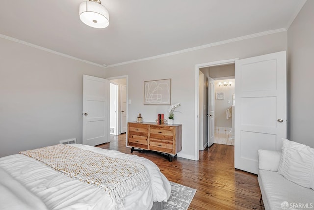 bedroom featuring crown molding, wood finished floors, and baseboards