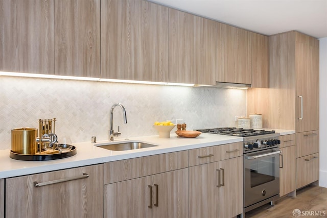 1288 Howard St Unit 505, San Francisco, CA 94103 - kitchen featuring high end stainless steel range, light brown cabinetry, and modern cabinets