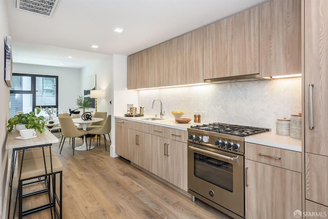 1288 Howard St Unit 505, San Francisco, CA 94103 - kitchen featuring stainless steel stove, light brown cabinets, light countertops, and recessed lighting