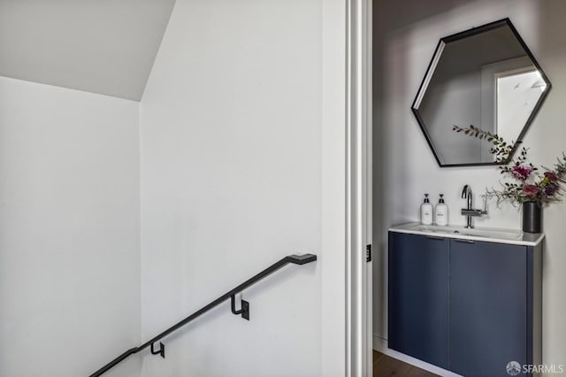 interior space with sink, blue cabinetry, and dark hardwood / wood-style flooring