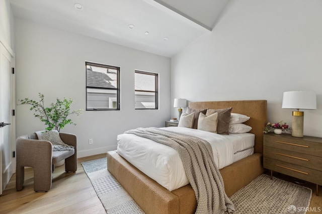 bedroom with light hardwood / wood-style flooring and vaulted ceiling