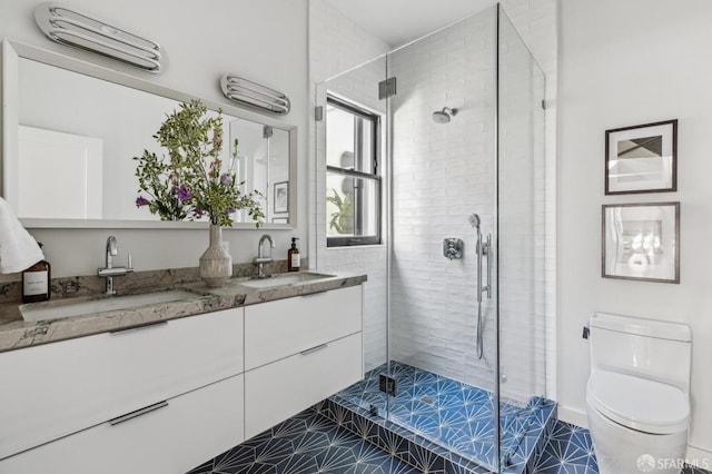 bathroom featuring vanity, toilet, tile patterned floors, and a shower with door