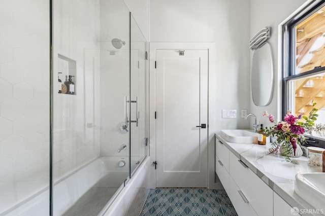 bathroom with vanity and bath / shower combo with glass door