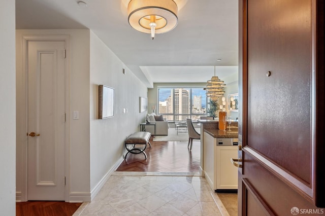 interior space featuring light tile patterned floors and baseboards